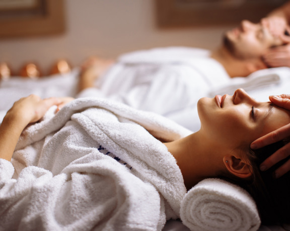 Happy Young Beautiful Couple Enjoying Head Massage Spa (1)